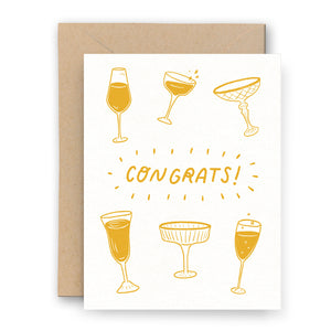 Letterpress Greeting card with orange vintage champagne glasses on a white background with the words "Congrats".